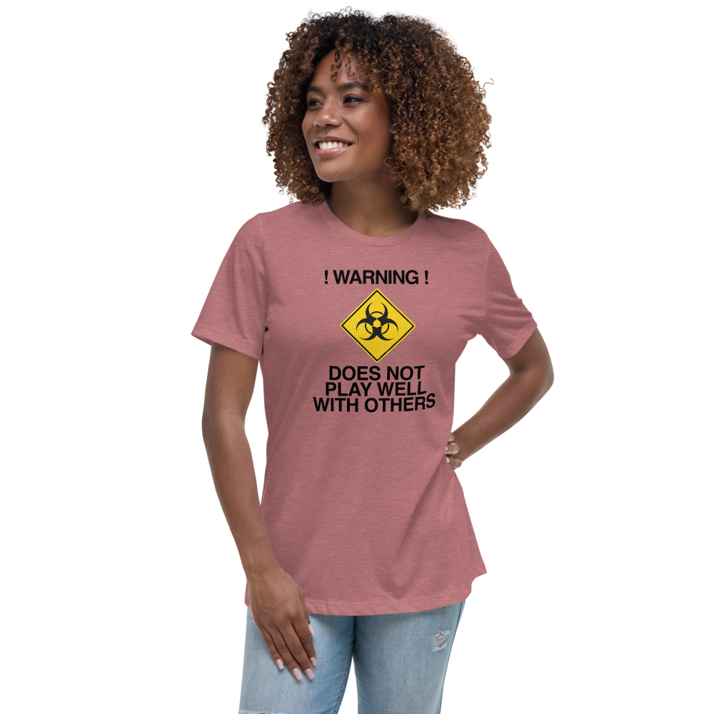 "!Warning! Does Not Play Well With Others" printed on a heather mauve women's relaxed t-shirt worn by a female