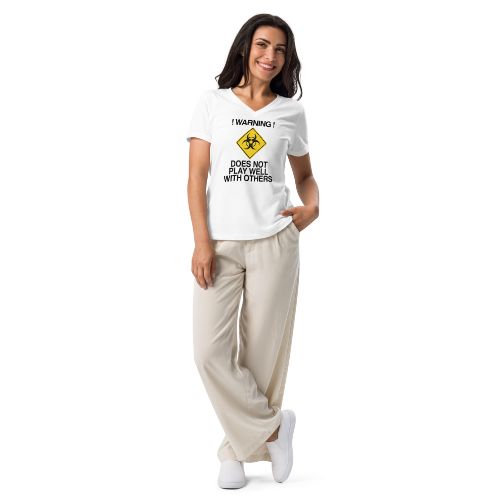 "!Warning! Does Not Play Well With Others" printed on a solid white blend women's relaxed v-neck t-shirt worn by a female
