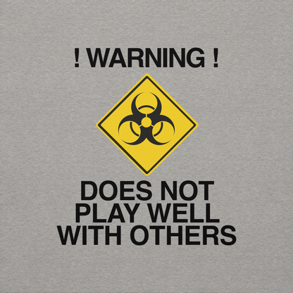 "!Warning! Does Not Play Well With Others" printed on a carbon grey background