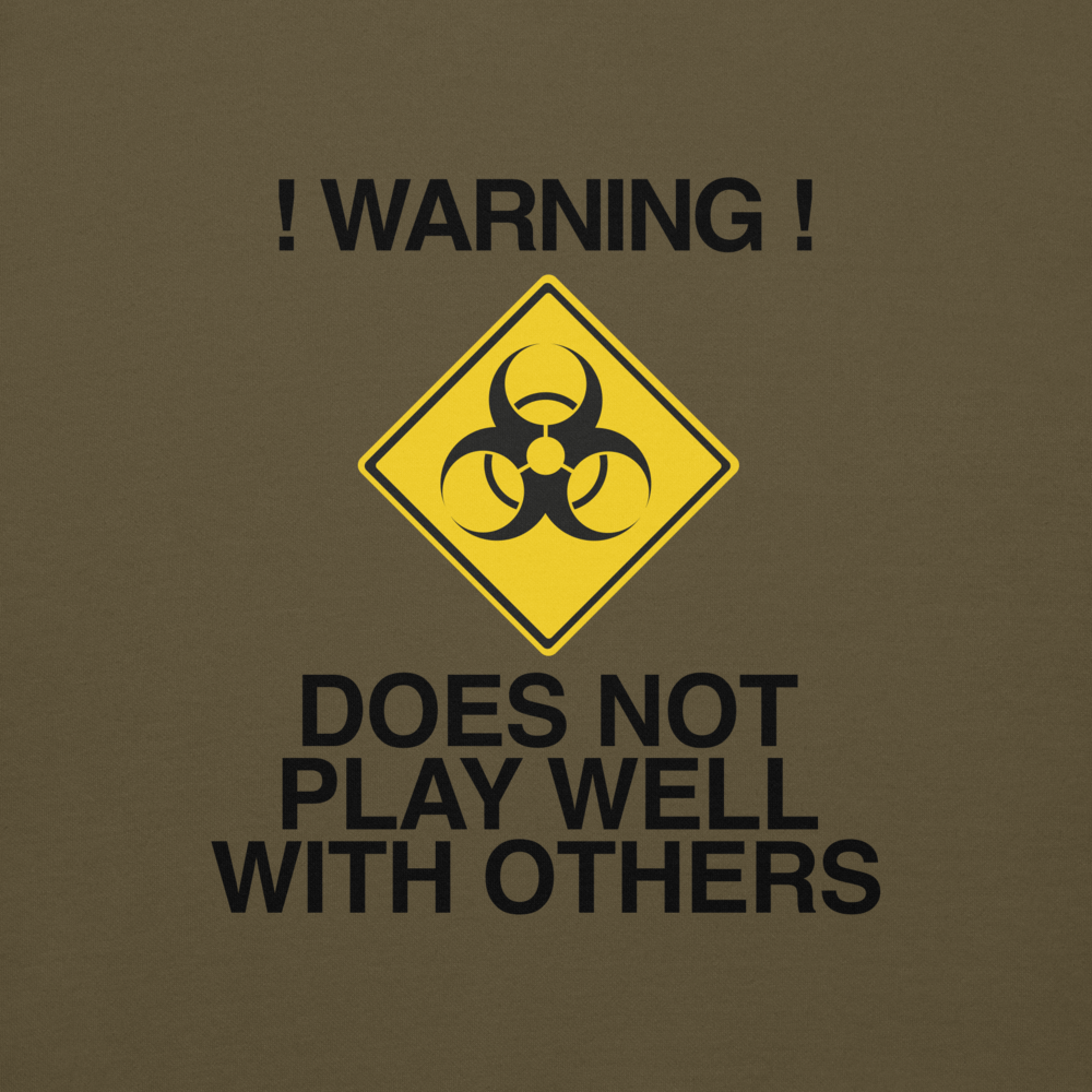"!Warning! Does Not Play Well With Others" printed on a military green background