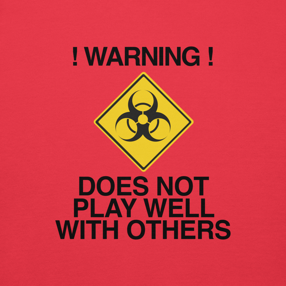 "!Warning! Does Not Play Well With Others" printed on a team red background