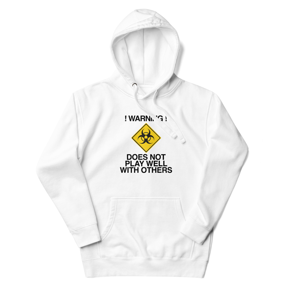 "!Warning! Does Not Play Well With Others" printed on a white unisex hoodie laying on a flat surface with the hood up