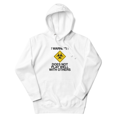 "!Warning! Does Not Play Well With Others" printed on a white unisex hoodie laying on a flat surface with the hood up