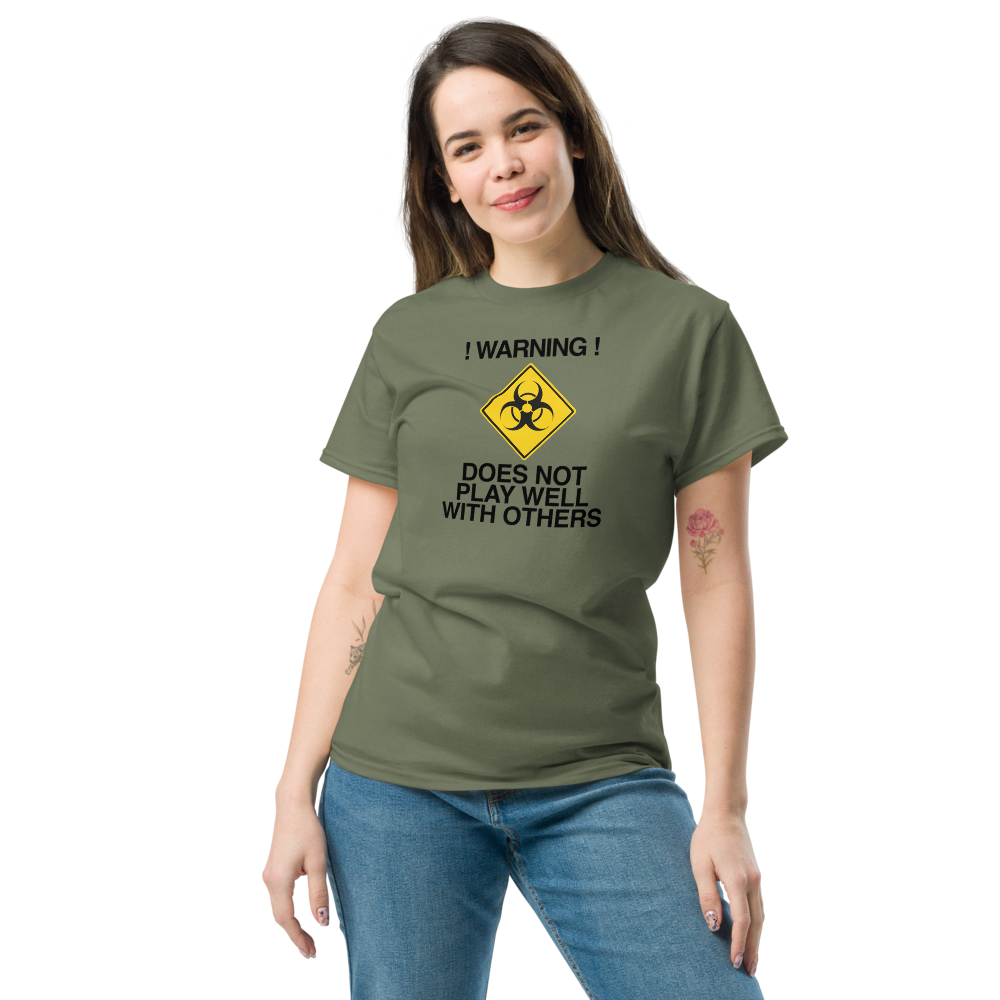 "!Warning! Does Not Play Well With Others" printed on a military green unisex classic tee worn by a female