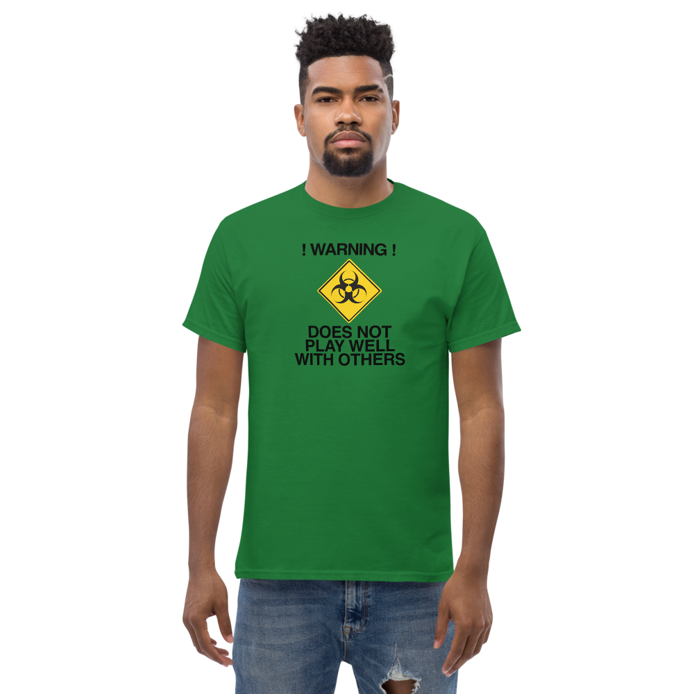"!Warning! Does Not Play Well With Others" printed on a turf green unisex classic tee worn by a male