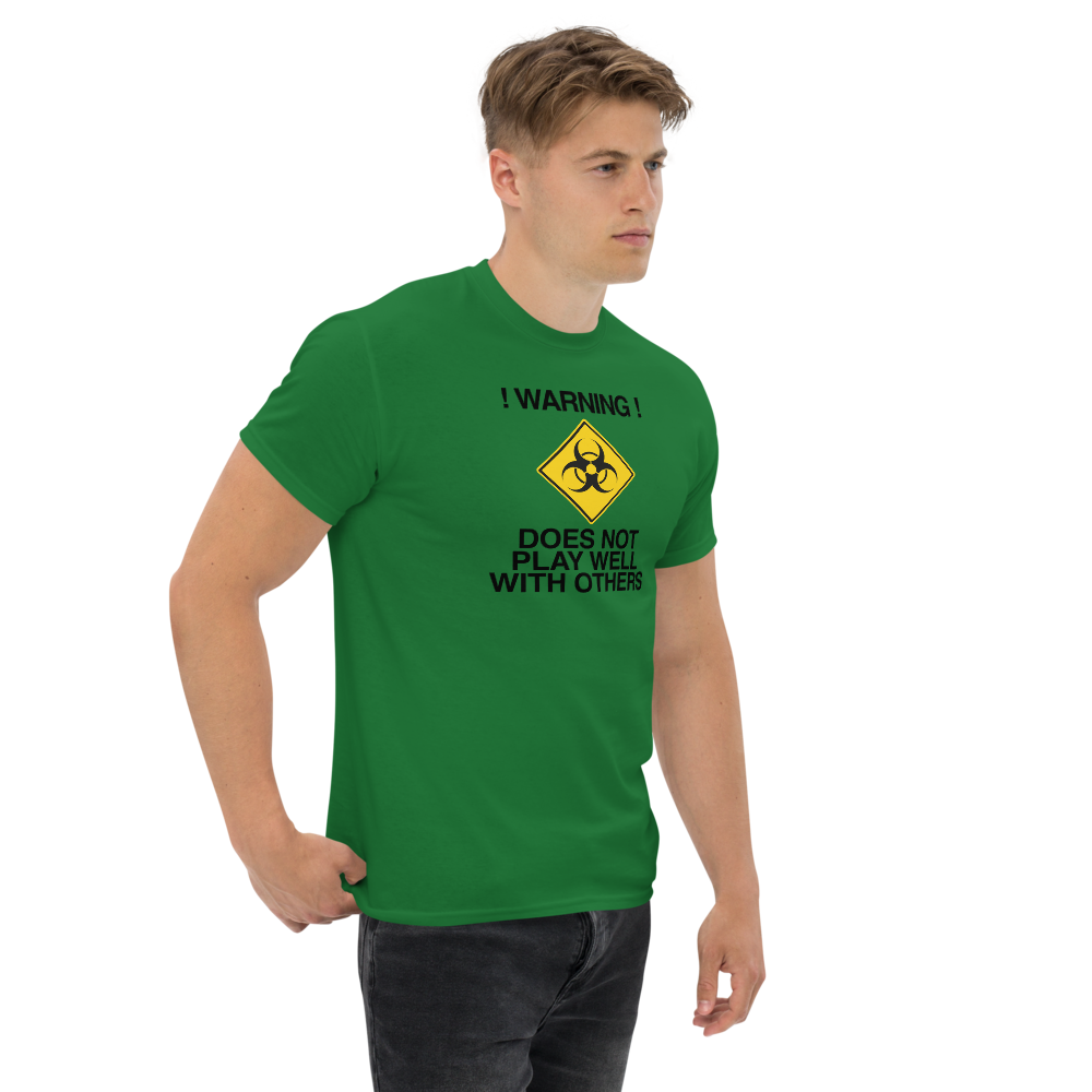 "!Warning! Does Not Play Well With Others" printed on a turf green unisex classic tee worn by a male