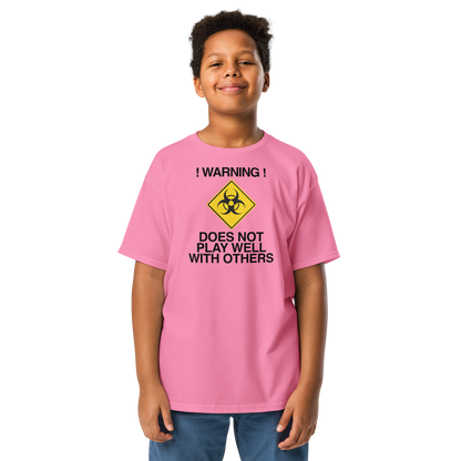 "!Warning! Does Not Play Well With Others" printed on a azalea youth classic tee worn by a male