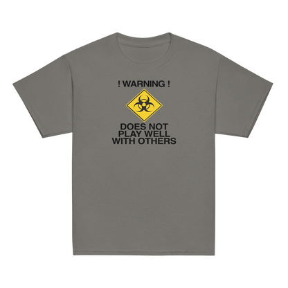 "!Warning! Does Not Play Well With Others" printed on a charcoal youth classic tee laying on a flat surface