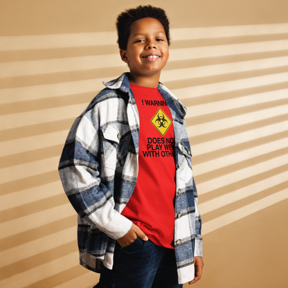 "!Warning! Does Not Play Well With Others" printed on a red youth classic tee worn by a male also wearing a jacket