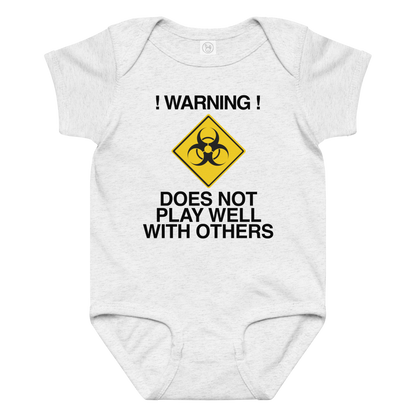 "!Warning! Does Not Play Well With Others" printed on a ash baby jersey bodysuit laying on a flat surface amongst other clothes