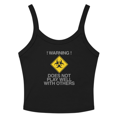 "!Warning! Does Not Play Well With Others" printed on a solid black blend women's micro-rib tanktop laying on a flat surface amongst sunglasses and shorts