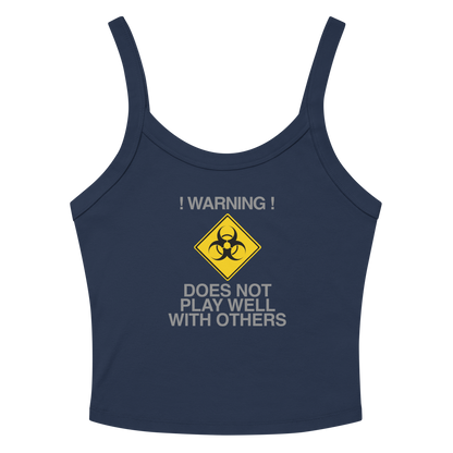 "!Warning! Does Not Play Well With Others" printed on a solid navy blend women's micro-rib tanktop laying on a flat surface amongst sunglasses and shorts