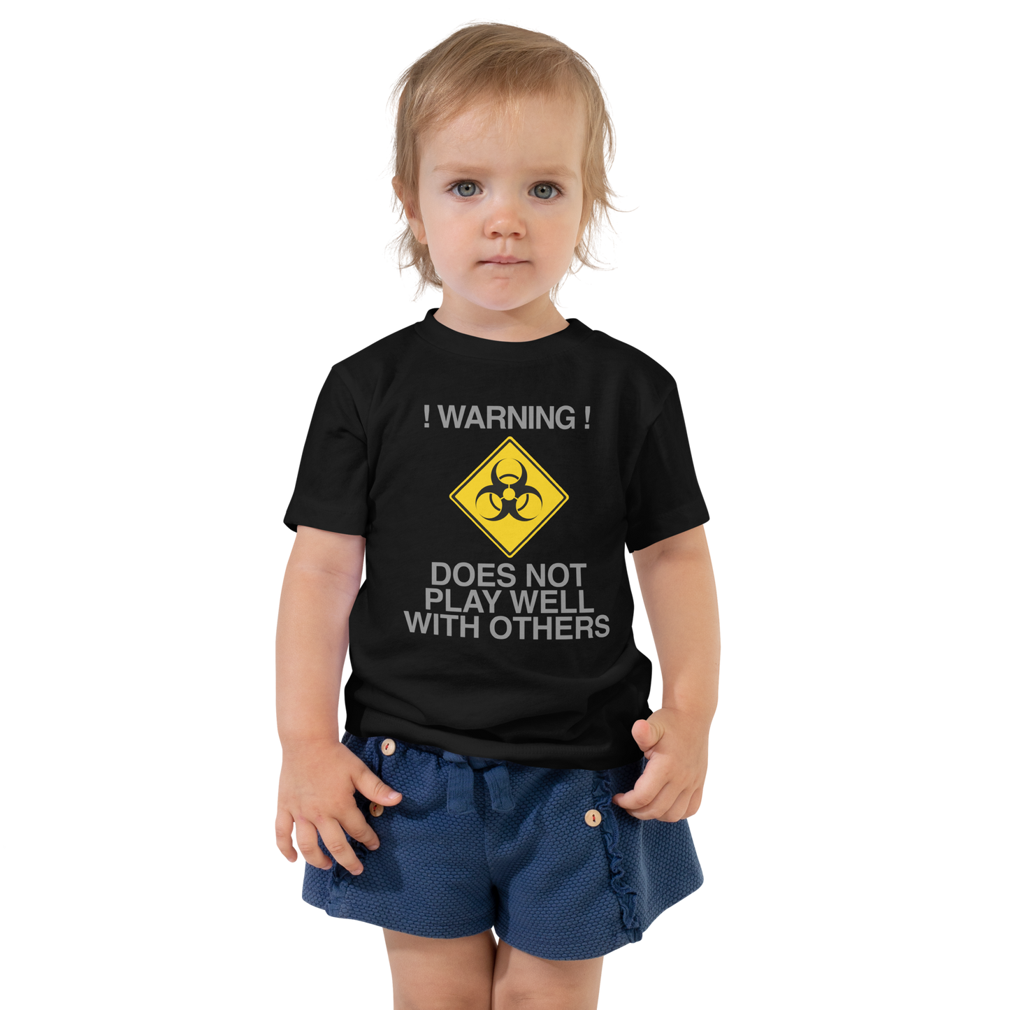 "!Warning! Does Not Play Well With Others" printed on a black toddler short sleeve tee worn by a female