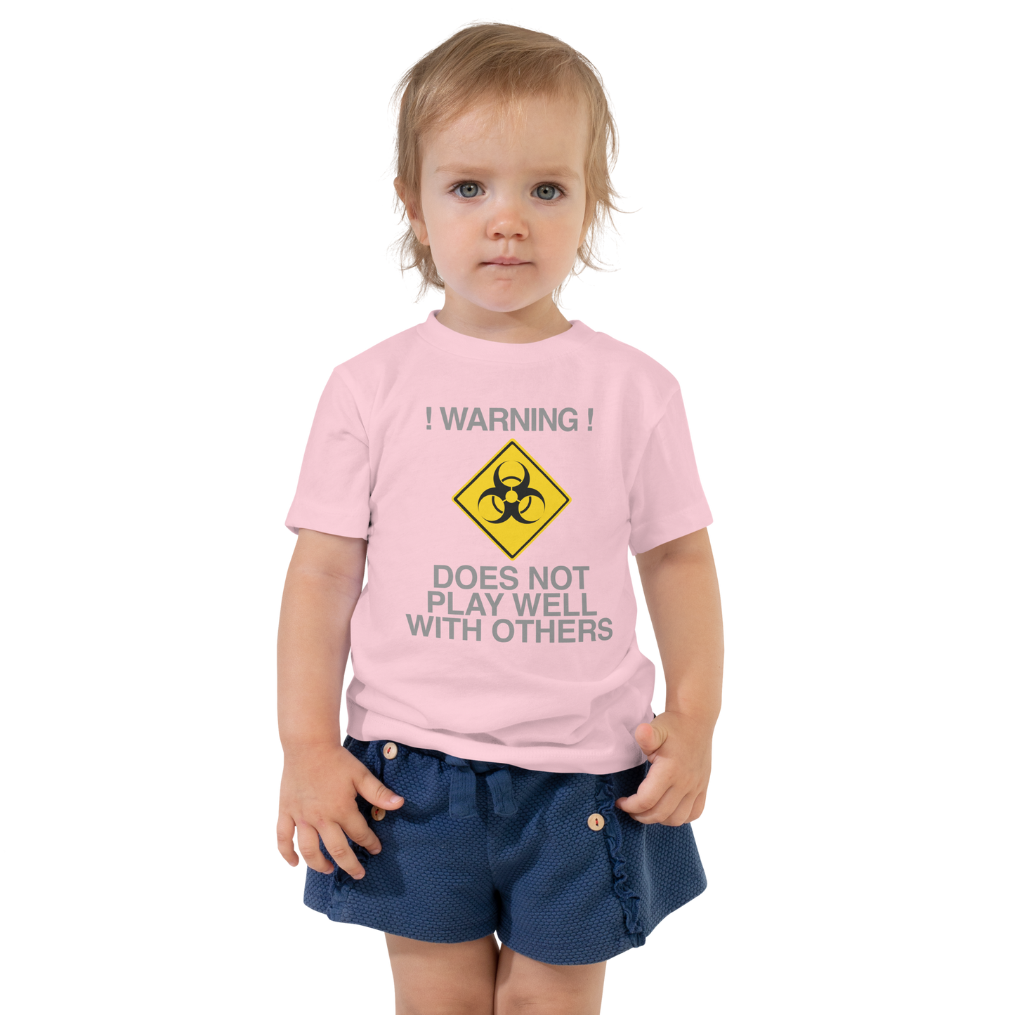 "!Warning! Does Not Play Well With Others" printed on a pink toddler short sleeve tee worn by a female