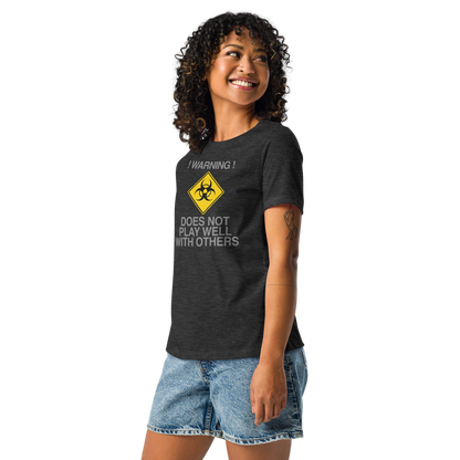 "!Warning! Does Not Play Well With Others" printed on a dark grey heather women's relaxed t-shirt worn by a female