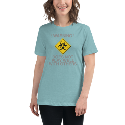 "!Warning! Does Not Play Well With Others" printed on a heather blue lagoon women's relaxed t-shirt worn by a female