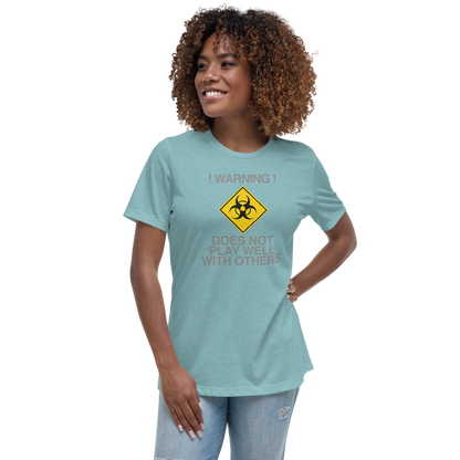 "!Warning! Does Not Play Well With Others" printed on a heather blue lagoon women's relaxed t-shirt worn by a female