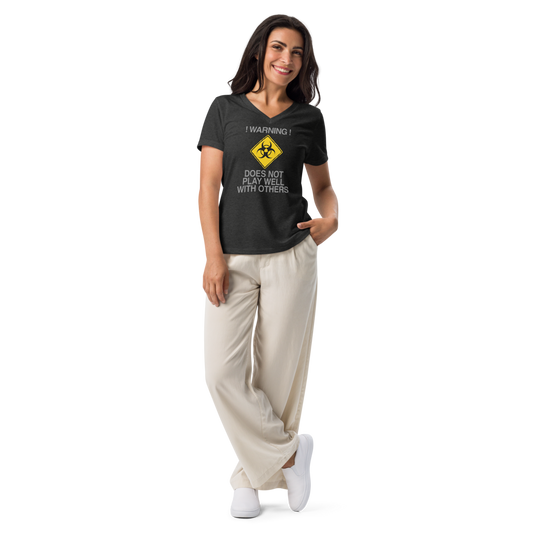 "!Warning! Does Not Play Well With Others" printed on a dark grey heather women's relaxed v-neck t-shirt worn by a female