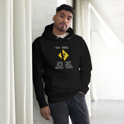 "!Warning! Does Not Play Well With Others" printed on a black unisex hoodie worn by a male