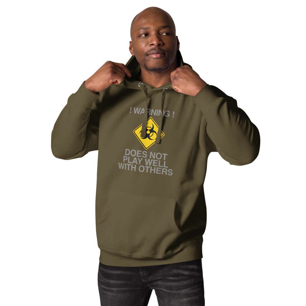"!Warning! Does Not Play Well With Others" printed on a military green unisex hoodie worn by a male