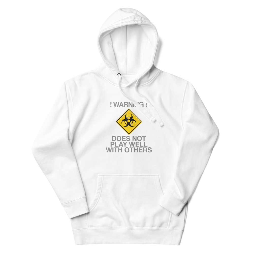 "!Warning! Does Not Play Well With Others" printed on a white unisex hoodie laying on a flat surface with the hood up