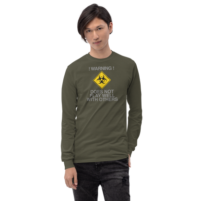 "!Warning! Does Not Play Well With Others" printed on a military green men's long sleeve shirt worn by a male