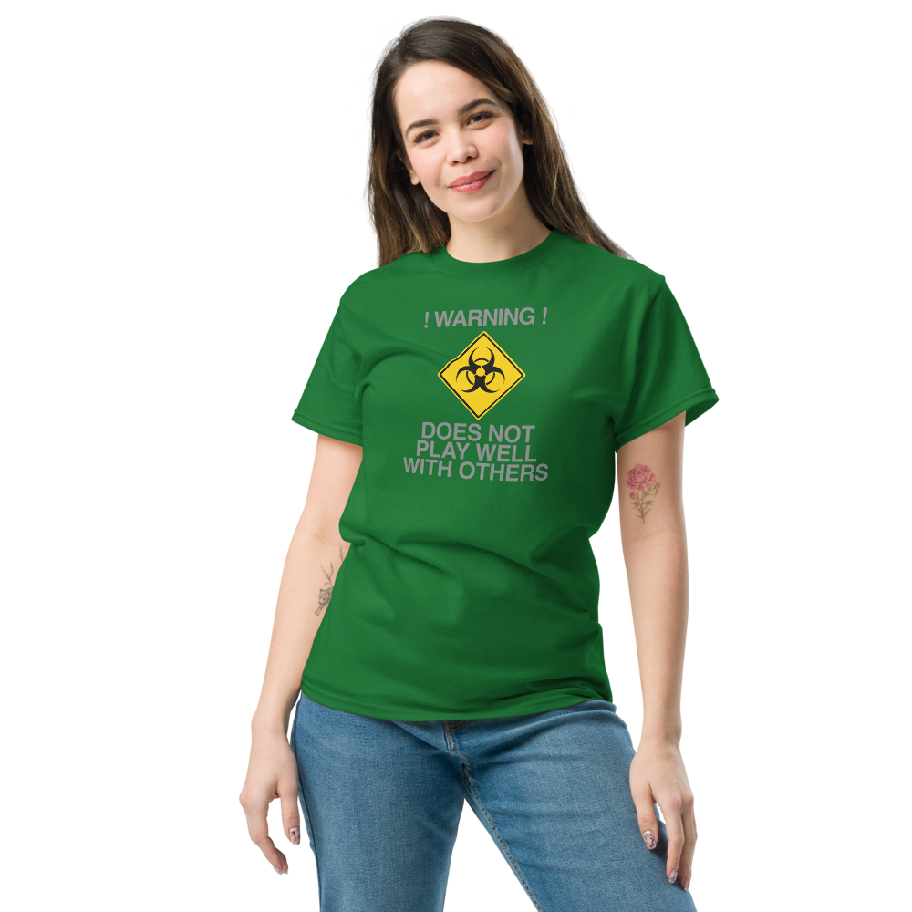 "!Warning! Does Not Play Well With Others" printed on a turf green unisex classic tee worn by a female