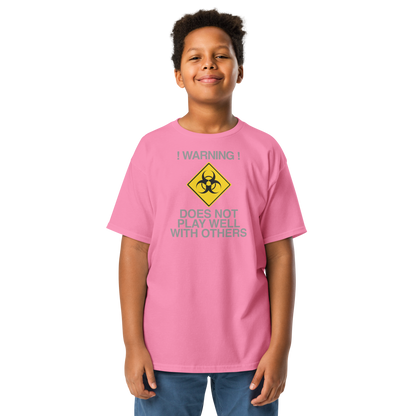 "!Warning! Does Not Play Well With Others" printed on a azalea youth classic tee worn by a male