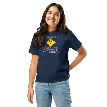 "!Warning! Does Not Play Well With Others" printed on a navy youth classic tee worn by a female