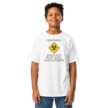 "!Warning! Does Not Play Well With Others" printed on a white youth classic tee worn by a male