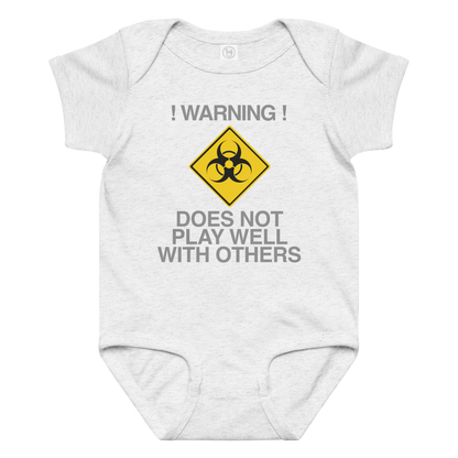 "!Warning! Does Not Play Well With Others" printed on a ash baby jersey bodysuit laying on a flat surface amongst other clothes