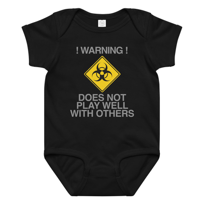 "!Warning! Does Not Play Well With Others" printed on a black baby jersey bodysuit laying on a flat surface amongst other clothes