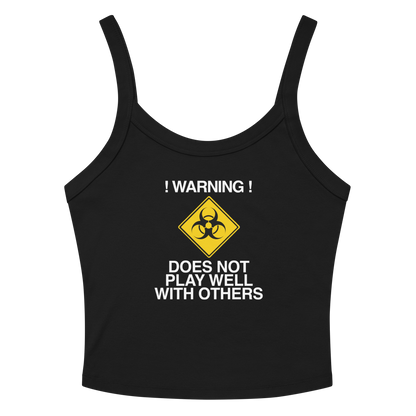 "!Warning! Does Not Play Well With Others" printed on a solid black blend women's micro-rib tanktop laying on a flat surface amongst sunglasses and shorts