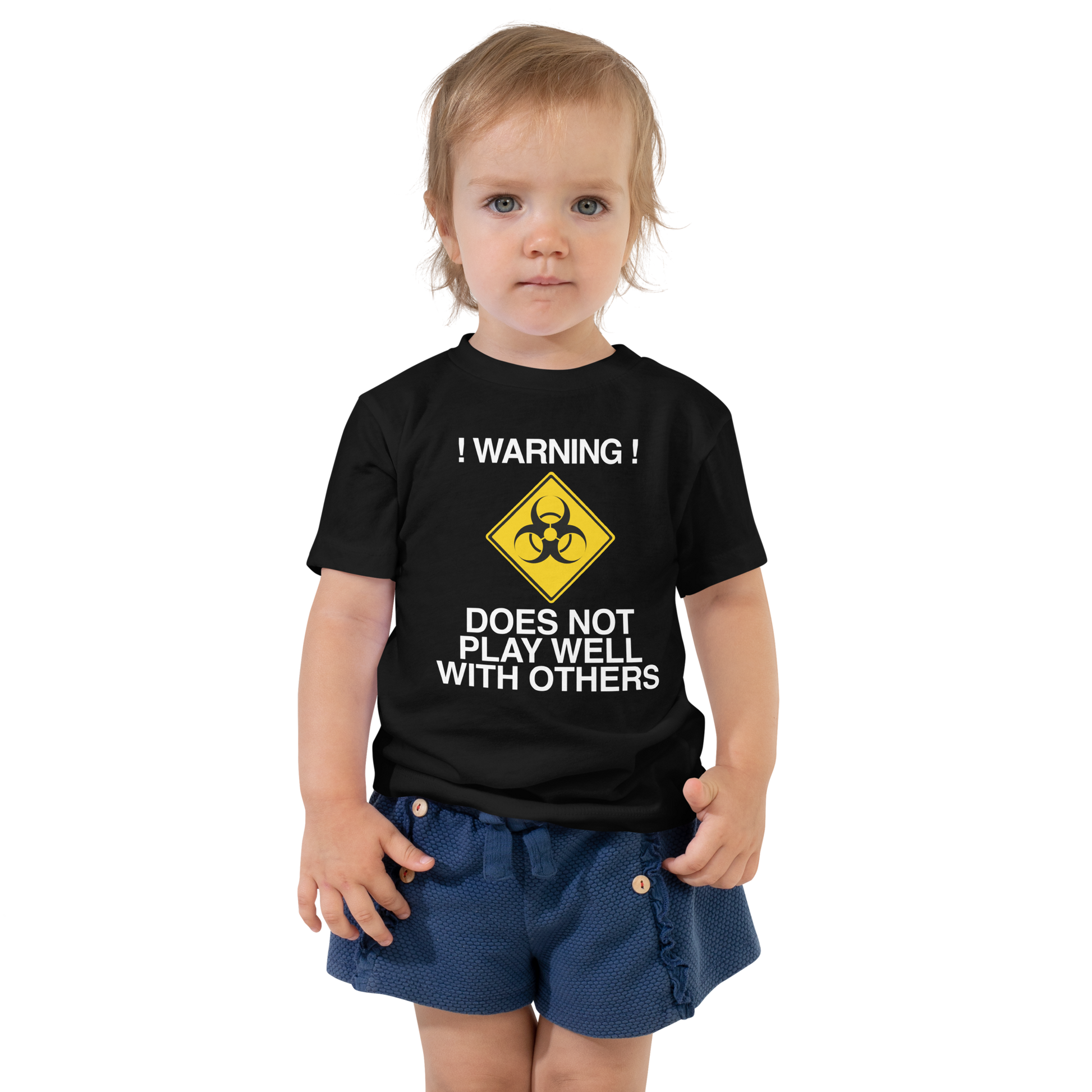 "!Warning! Does Not Play Well With Others" printed on a black toddler short sleeve tee worn by a female