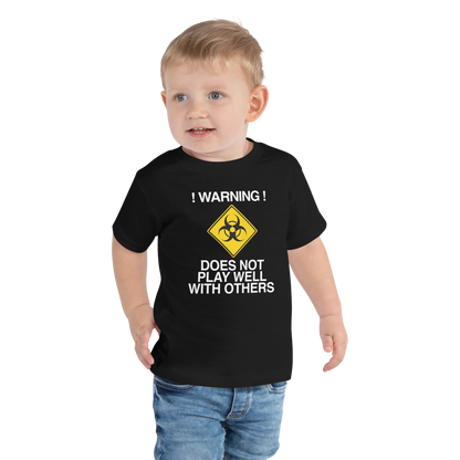 "!Warning! Does Not Play Well With Others" printed on a black toddler short sleeve tee worn by a male