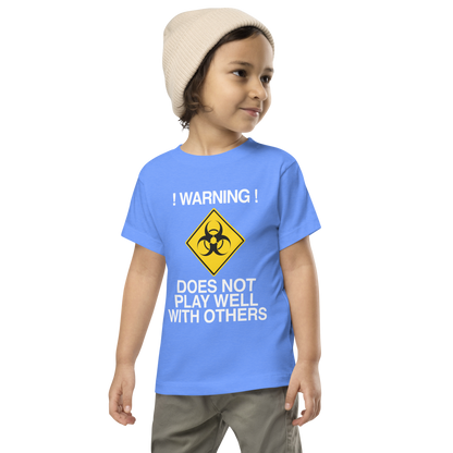 "!Warning! Does Not Play Well With Others" printed on a heather columbia blue toddler short sleeve tee worn by a male wearing a cap