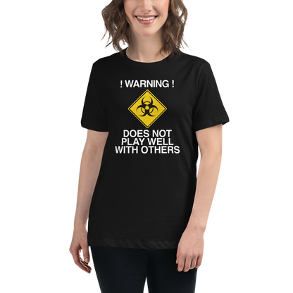 "!Warning! Does Not Play Well With Others" printed on a black women's relaxed t-shirt worn by a female