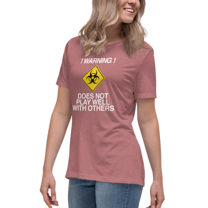 "!Warning! Does Not Play Well With Others" printed on a heather mauve women's relaxed t-shirt worn by a female