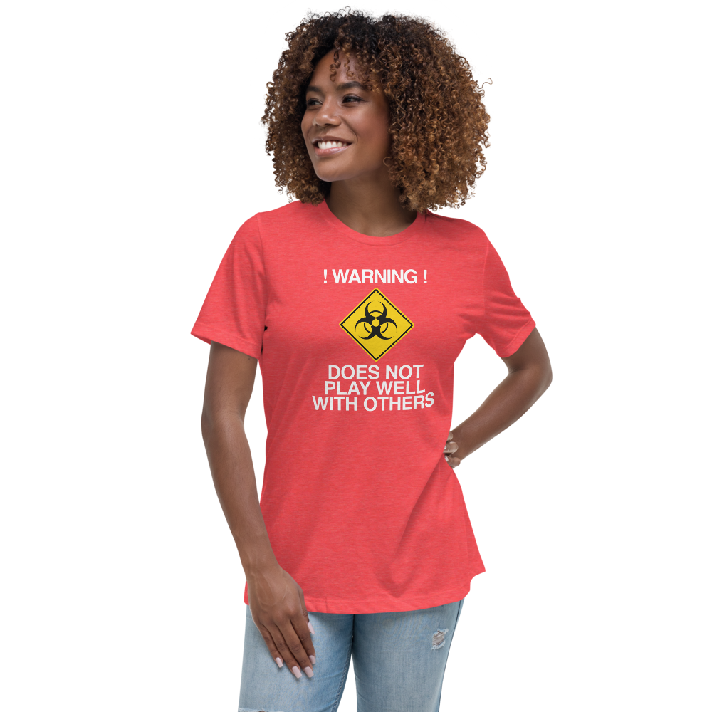"!Warning! Does Not Play Well With Others" printed on a heather red women's relaxed t-shirt worn by a female