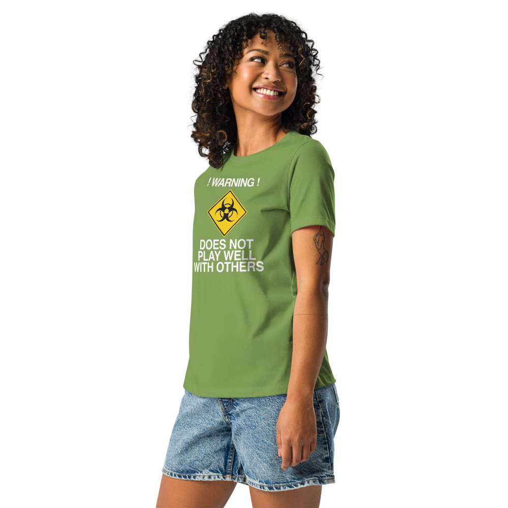 "!Warning! Does Not Play Well With Others" printed on a leaf women's relaxed t-shirt worn by a female
