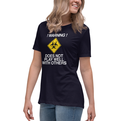 "!Warning! Does Not Play Well With Others" printed on a navy women's relaxed t-shirt worn by a female