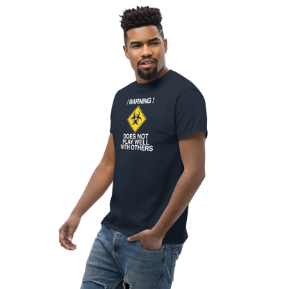 "!Warning! Does Not Play Well With Others" printed on a navy unisex classic tee worn by a male