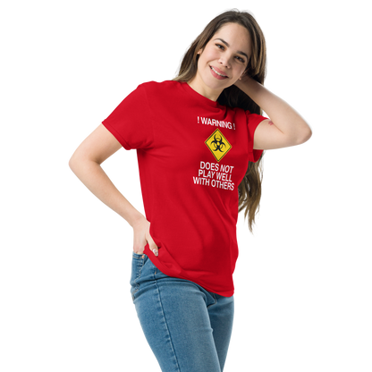 "!Warning! Does Not Play Well With Others" printed on a red unisex classic tee worn by a female