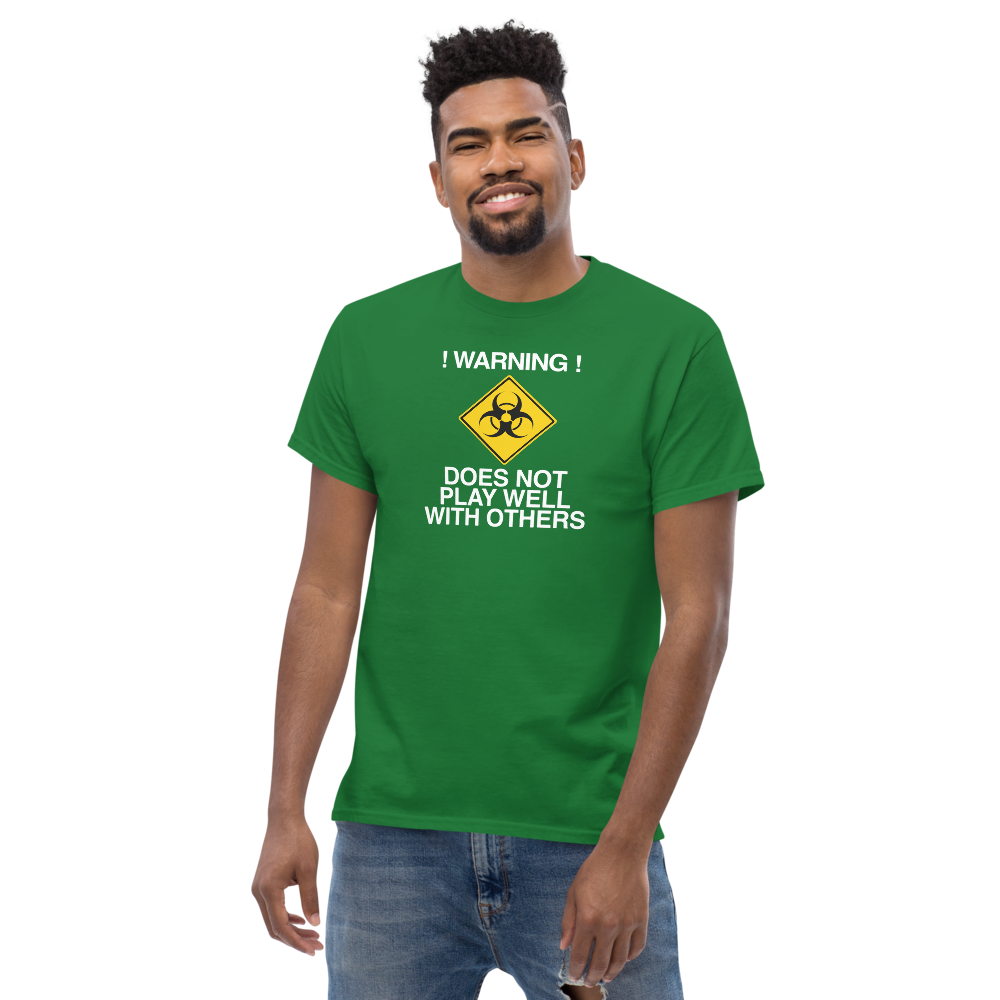"!Warning! Does Not Play Well With Others" printed on a turf green unisex classic tee worn by a male