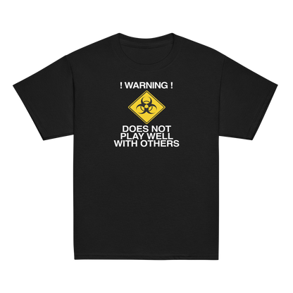 "!Warning! Does Not Play Well With Others" printed on a black youth classic tee laying on a flat surface