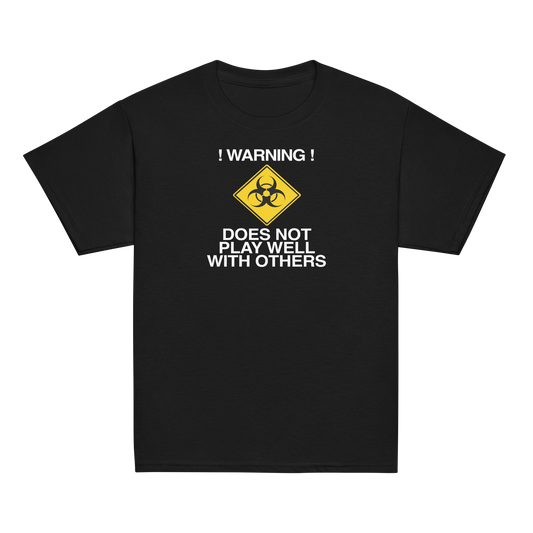 "!Warning! Does Not Play Well With Others" printed on a black youth classic tee laying on a flat surface