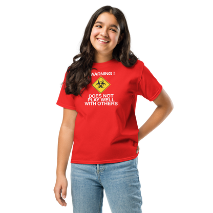 "!Warning! Does Not Play Well With Others" printed on a red youth classic tee worn by a female