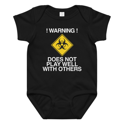 "!Warning! Does Not Play Well With Others" printed on a black baby jersey bodysuit laying on a flat surface amongst other clothes