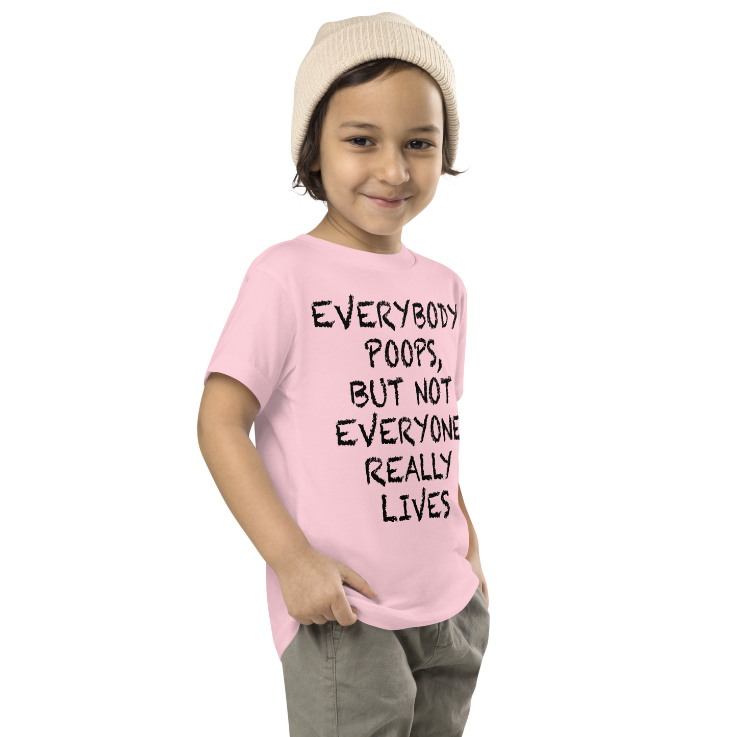 "Everybody poops, but not everyone really lives" printed on a pink toddler short sleeve tee worn by a male who is also wearing a knit cap