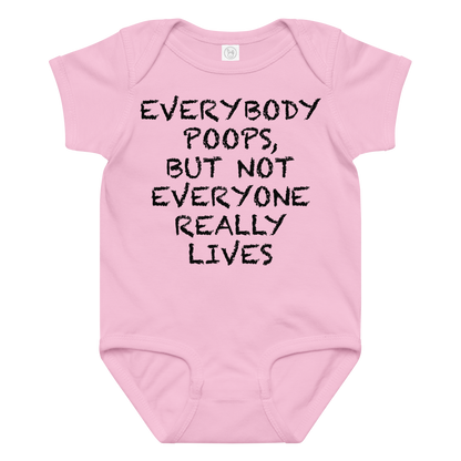 "Everybody poops, but not everyone really lives" printed on a pink baby jersey bodysuit laying on a flat surface amongst other clothes